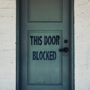 blue wooden door with white concrete wall