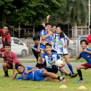 a group of young people playing a game of soccer