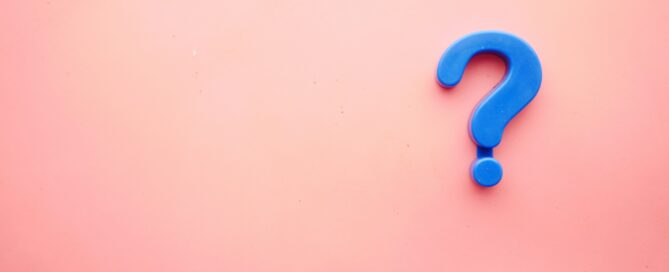 a blue question mark on a pink background