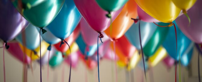 selective focus photography of assorted-color balloons