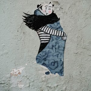 man hugging woman wall painting